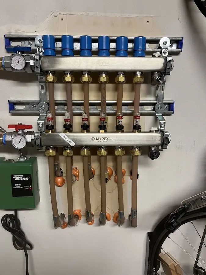 Plumber performing Water Heater Repair at a residential property in New Boston